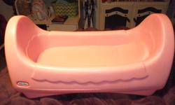 I'm Kimberly and I'm selling a medium sized baby doll musical cradle. It's pink, heavy in weight and makes a musical sound when you rock back and forth. It usually fits small dolls and has a place for a pillow. It's really cute. I'm selling it for five