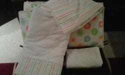 4 piece set, includes thick bumper (Green/white check reverses to large multi polka dots), reversible comforter (polka dots reverse to stripes) Polka dot fitted sheet, and striped crib ruffle.
It is very gently used, as it was for our vacation condo. Some