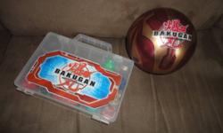 9 Bakugan toys, two carrying cases and and an assortment of cards.