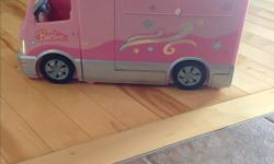 Barbie camper van that plays music and has flashing lights for the hot tub. Also has sound for the car horn. Great condition.