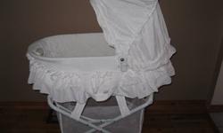 White bassinet that has switch for vibration (low/high), music, nightlight, or music and light.  Also has storage basket underneath.  Easily snaps off of base and has handles for portability.  Excellent condition from smoke-free home.  $40.00
 
Price will