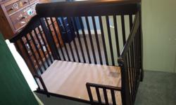 Convertible crib. The picture do not show it, but there is a part that goes in front that makes this a full crib. It also converts to a day bed with railings (as shown in pictures), and then, if you wish you can also purchase side rails to eventually