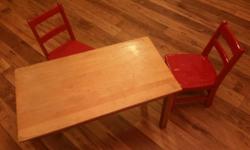 Children's solid wood table and chair set. 36 inches wide, 19.5 inches deep and 21 inches tall. Comes with 2 red chairs. Asking $45