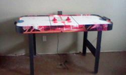 Air hockey table..complete with three pucks and two paddles..score keeping does not work..good shape..