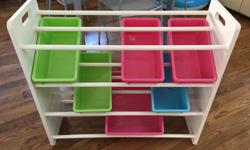 In great condition, children's shelving unit with green pink and blue boxes. 5 small bins and one large bin.
Measures 31" high, 34" wide and 12" deep.