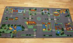 Extra large, high quality "City Pay Rug" (37" x 80"). Excellent condition, like-new. No marks or stains on fabric. Has roads for little cars to drive on.  Can drive to car wash, gas station, beach area, hotel, police/fire station etc. Great for kids who