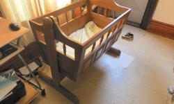 have a cradle home made its real nice a must see. it swings side to side solid and safe for your little one