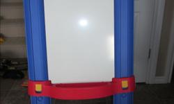 This double-sided easel offers a chalkboard on one side and a dry erase board on the other. Also includes art display clips on both sides and a paper dispenser on top (with some paper left to pull down and draw on). LIKE NEW!! In excellent condition.