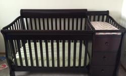Espresso colour crib with removable change table and drawers. Mattress included.