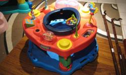 This is the play saucer for a baby to sit in called Exersaucer the Learning Center. Inside the Learning Center baby can bounce, rock, swivel and spin while playing with nine toys and sounds.
The item has some scratches we do not need it anymore. I also