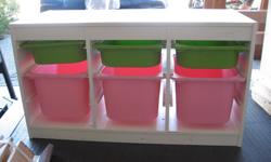 3 large pink and 3 small green plastic bins in a white laminate frame. Needs some cleaning with baking soda, but these units are durable.