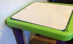 Small child's art table. Top is whiteboard material and reversible. The top lifts off and there is storage for markers, etc. Good condition.
