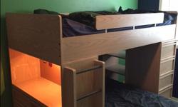 4 piece kid's bedroom set in great condition. The set has a top bunk with a side desk on one side and shelves on the other side. Another twin bed (lower bunk) on wheels that runs perpendicular to the top bunk or it can be moved around as needed. Also,