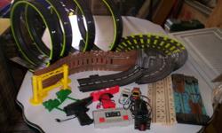 Race track has 4 loops, suspended bridge, log ride over water, rough road, 2 race cars, lap counter and lots of track.  Not all the pieces are shown in the picture, just the featured items.  We had it set up on a 4' x 8' table.  If you want, we can add