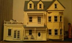 Very Beautiful wood dollhouse that has only been on display not played with. It is 38"wide by 29" high and 16.5" deep not including the front porch and balcony. The top floor opens and the rest of the house opens with swing doors. In the last photo is the