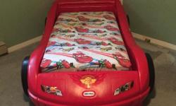 Disney Lightning McQueen toddler bed with crib mattress. One side is for infants, and the other is for toddlers. GUC some of the stickers are peeling off from ware (price is reflective of this as it is less than half of what we paid) but otherwise in