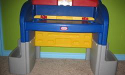This desk can be used flat with storage on the sides (blue) for pencils, crayons, or crafting items; or on an angle with the yellow top pulled over.  The sides (grey) and top (red) of the desk also provide lots of extra space to keep things organised.