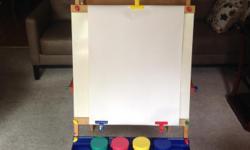 Two sided easel with chalkboard and white board. Also includes paint containers. Good Condition.