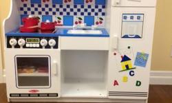 Melissa & Doug Kitchen with pots, dishes, food, apron, and oven mitt. In excellent shape. Can deliver