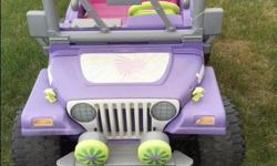 Pink and purple motorized Barbie Jeep with 12 volt rechargeable battery. Has 2 forward speeds: fast and slow and reverse. Suitable for a child aged 2-5. Has a battery (C) powered radio. In good condition although the color has faded from being in the sun.