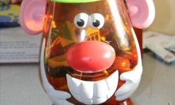 Mr. Potato Head in a neat and tidy large potato head container. Container has a few sets including the Buzz Light year potato head.