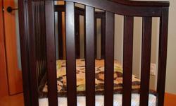 Expresso coloured crib made by Munire Furniture. The crib converts to a daybed. Mattress is a Simmons Beauty Sleep. The bedding can be purchased separately for $50.00. All can be purchased as a package for 200.00.