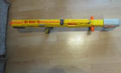 More than 3 feet long, can hold N Strike clips, comes with one 6 round clip and 6 rounds, comes with barrel extension