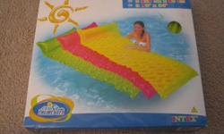 For sale a brand new, sealed package, Tote-N-Float Wave Mat.  Innovative design follows boy contour, rolls up inflated, double sealed edges, and repair patch.