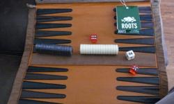 Roots Canada, Rollup Backgammon. New. Great present.
The discs and dice are cleverly and securely zipped away at one end of the board, which is then rolled up and secured by two strong poppers. This makes the rollups ideal for travelling!