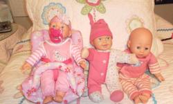 My name's Kimberly and I'm selling three cute little cushy baby dolls and carrier. One doll has a magnetic soother that you can remove and the other doll is mechanical and kicks her legs and moves her head and giggles gleefully! All three are in good