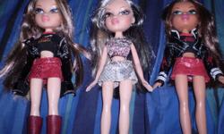 Three Rock Angels bratz and 2 others with clothes and accesories with 2 micraphone stands.