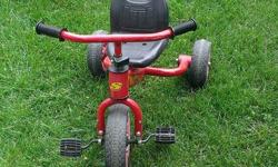 Topper tricycle with handle to help push from the back. In good condition.