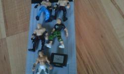 Wwe Wrestling Ring includes: 5 mini wrestlers (john cena, 2 canes, ray mystyrio, and and unfortantly we do not know the name to the last one)also includes, fold out stairs and pull walk way/ramp and some other little wrestling toys. FIVE DOLLERS OBO