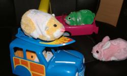 Three Zhu Zhu pets hamsters and one Zhu Zhu pet bunny, woody wagon and surfboard and another vehicle, all as shown, $12