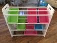 Children shelving unit with colourful bins.